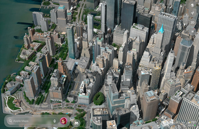 App Mapas a mostrar uma vista aérea detalhada de uma cidade com edifícios, ruas e espaços verdes